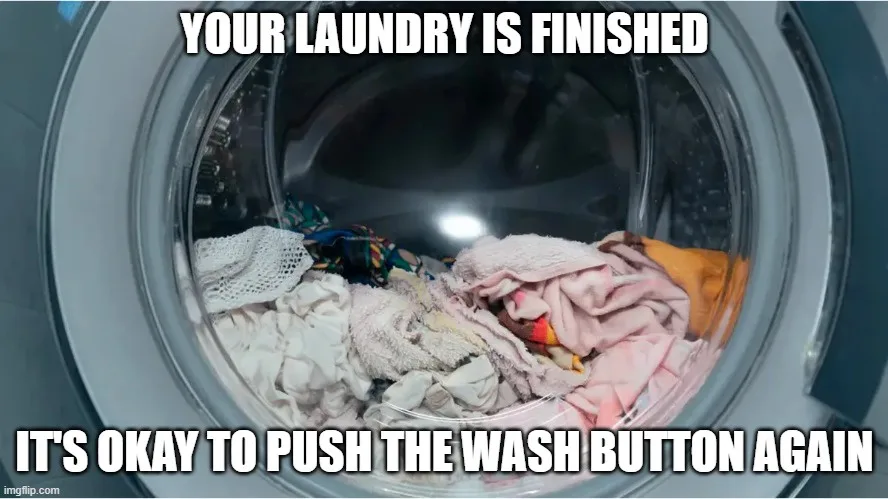 A close-up photo shows the interior of a front-loading washing machine filled with wet, rumpled laundry including towels and…