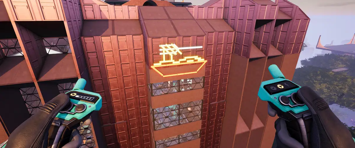 A first-person view from a video game shows a player holding two teal gadgets while looking up at a building with a glowing…