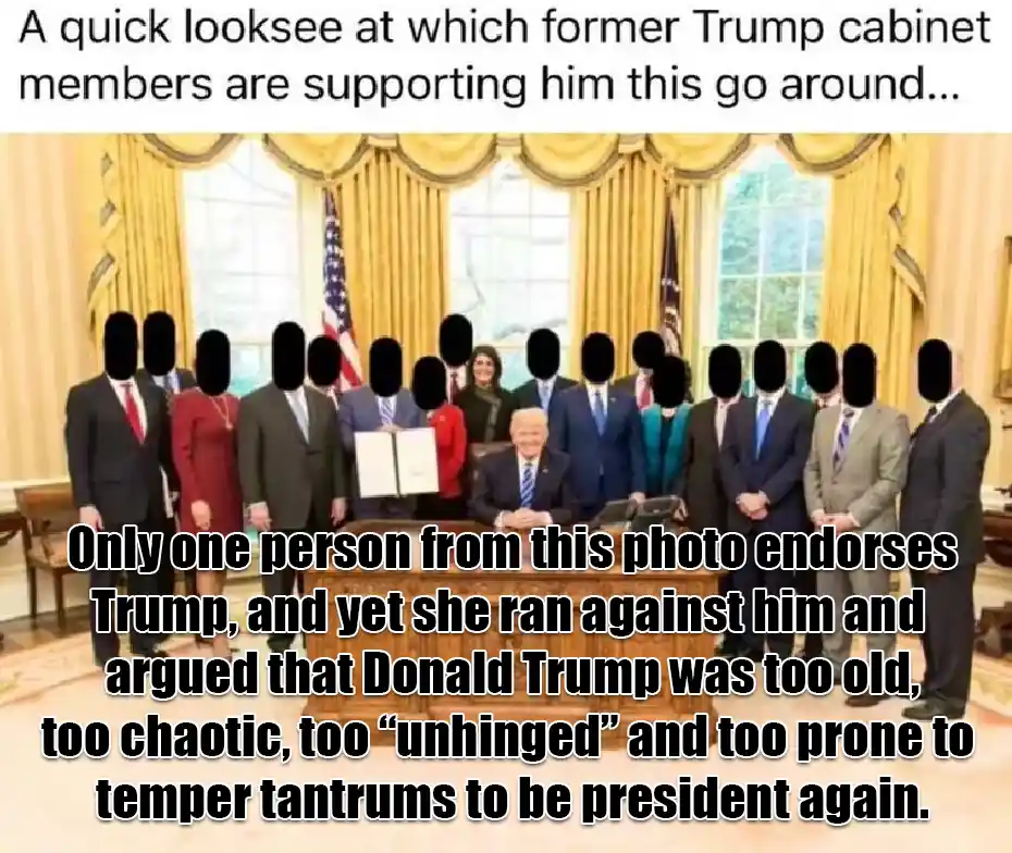 The image shows a group of people, presumably former Trump cabinet members, standing behind a desk in an official-looking…