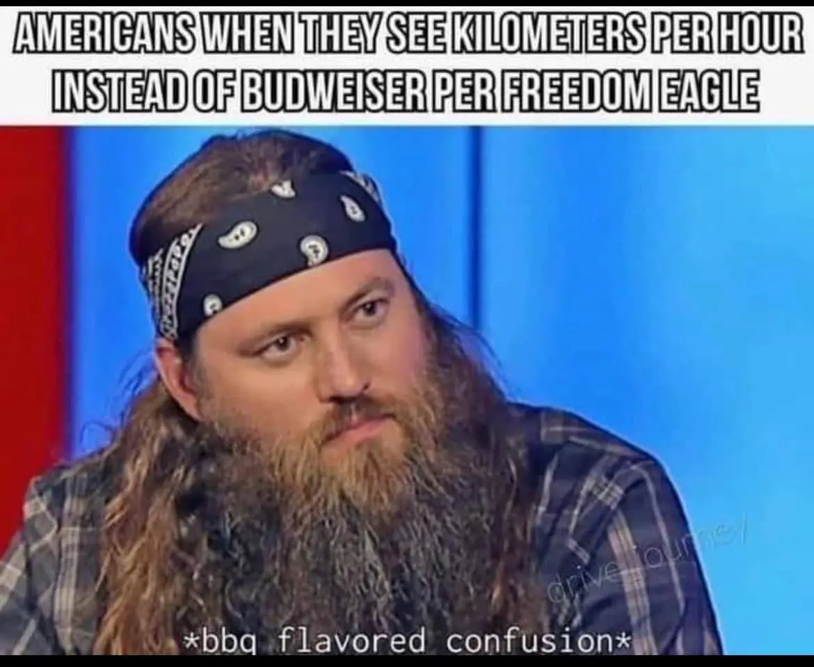 A man with a long beard and bandana looks confused, overlaid with text reading 'AMERICANS WHEN THEY SEE KILOMETERS PER HOUR…