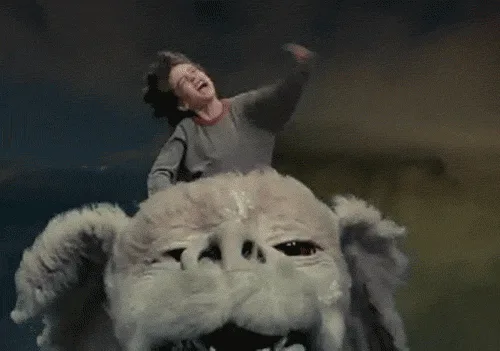 A six-panel image sequence from the movie 'The NeverEnding Story' shows a young boy riding a large, fluffy, white creature…