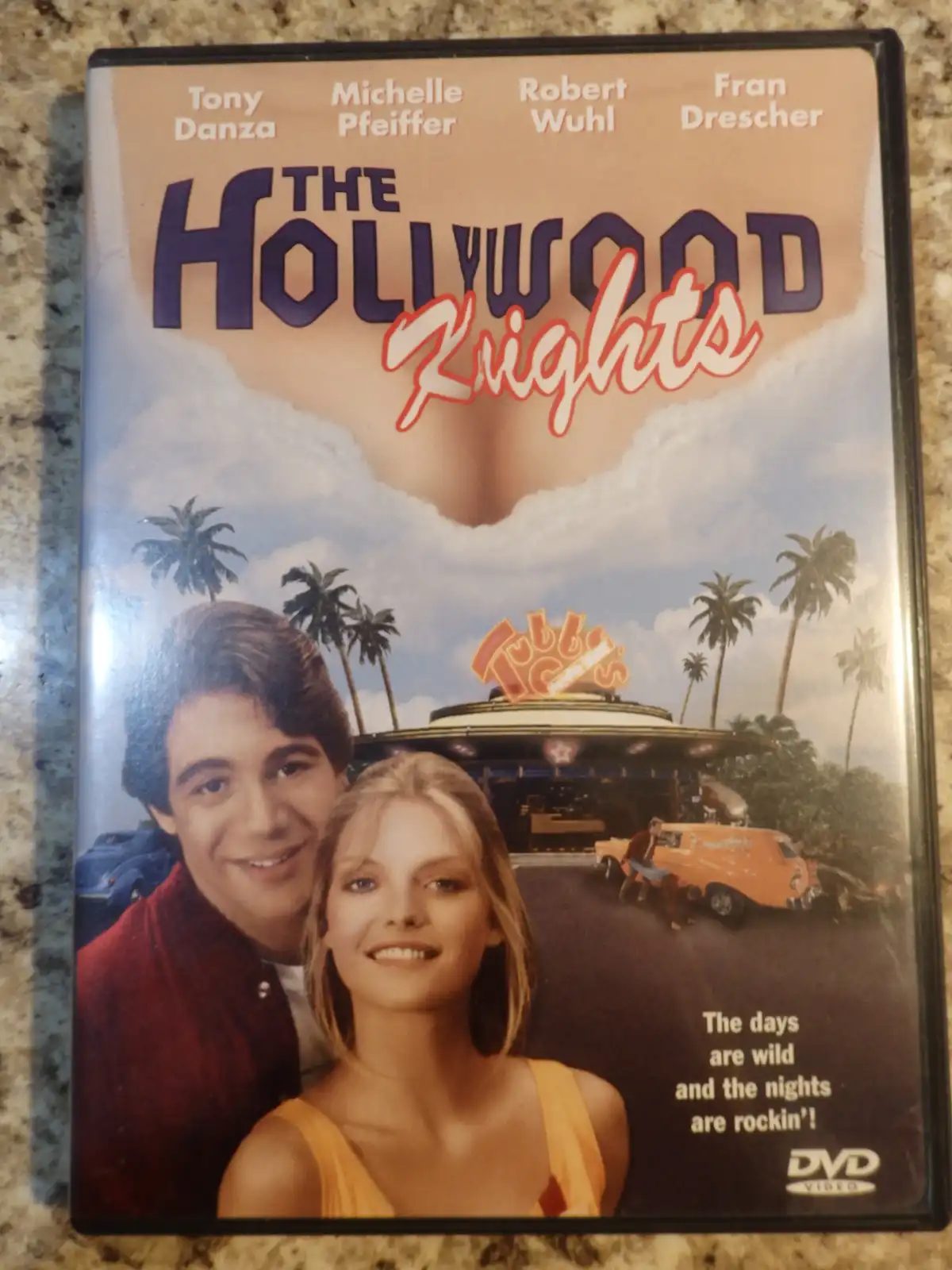A DVD cover for the 1989 film 'The Hollywood Knights' featuring actors Tony Danza, Michelle Pfeiffer, Robert Wuhl, and Fran…