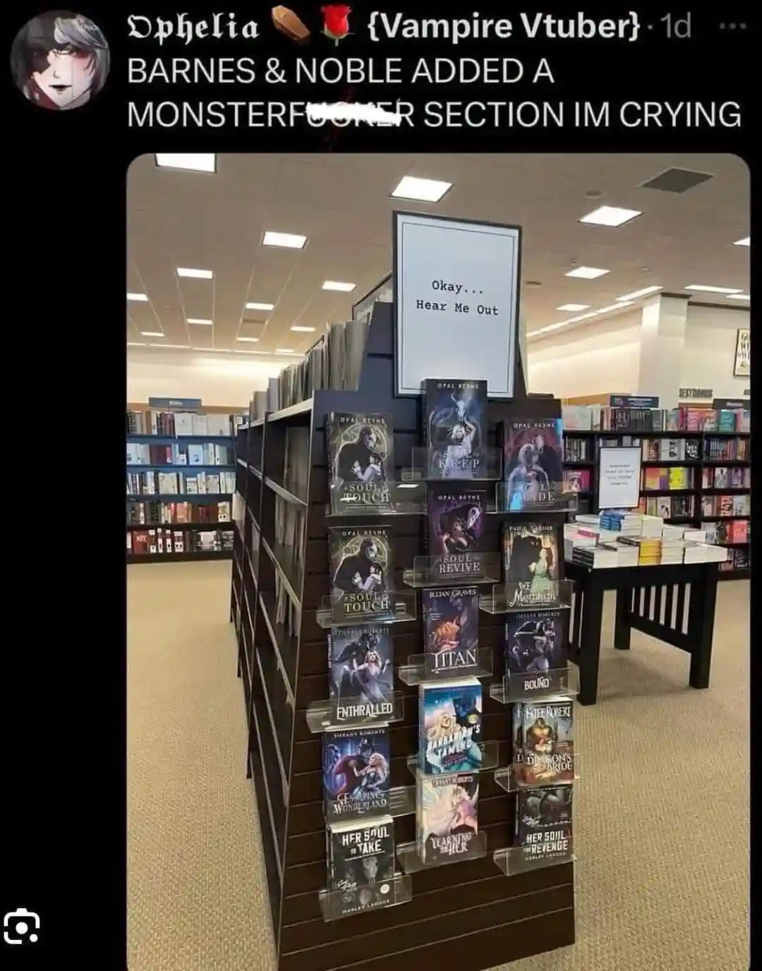 A Barnes & Noble bookstore display features a tall, dark wooden rack filled with romance novels featuring supernatural or…