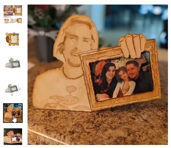 A wooden carving of Jesus Christ with a hand holding up a photo frame containing a smiling family photo. The carving is…
