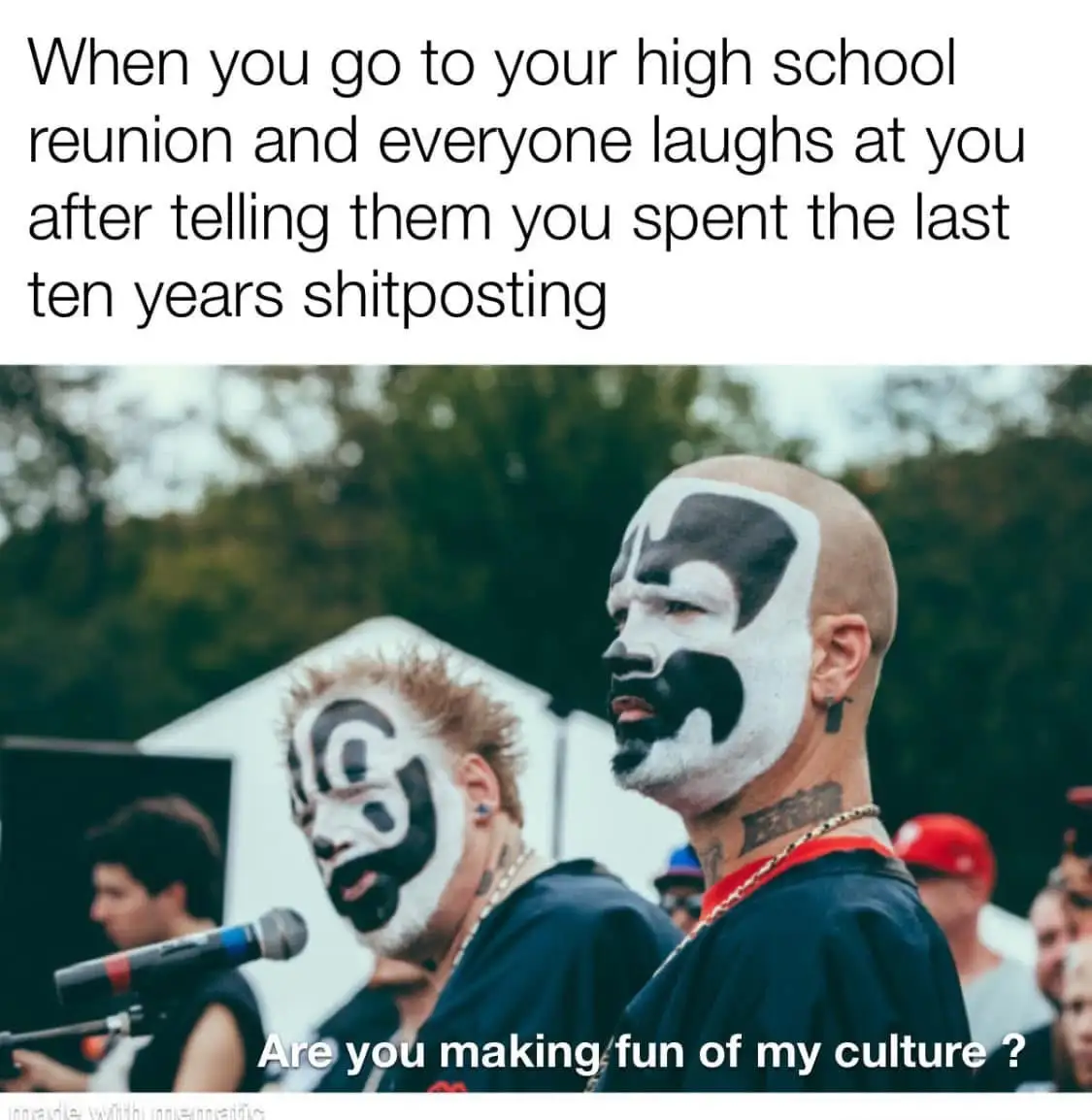 The image shows two men with black and white face paint resembling traditional tribal or cultural markings, standing…