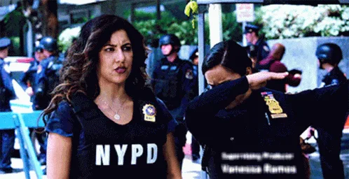 A sequence of frames shows a female NYPD officer performing the 'dab' dance move while another officer behind her also dabs…