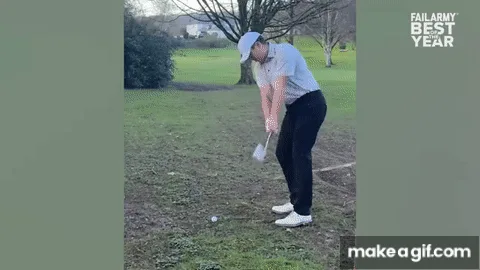 A man in a light blue shirt and dark pants is shown in a sequence of frames on a grassy golf course, swinging a golf club…