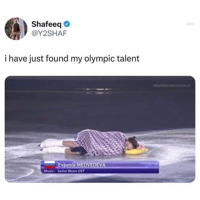 A female figure skater, identified as Evgenia MEDVEDEVA, is lying face-down on an ice rink, seemingly exhausted or defeated…