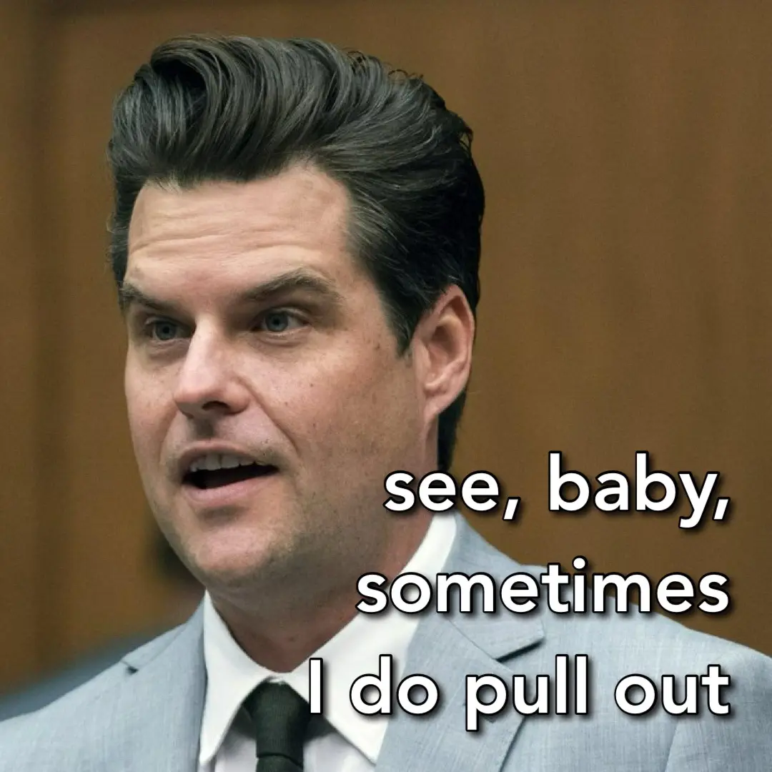 A man with styled dark hair and a light gray suit is shown in a courtroom setting, looking slightly to his right with a…
