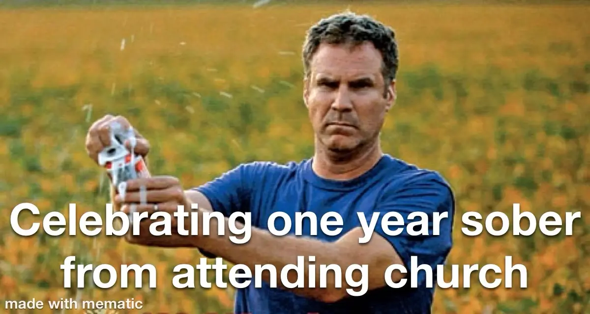 A man in a blue t-shirt stands in a field of yellow flowers, holding a can and spraying its contents outward with a…