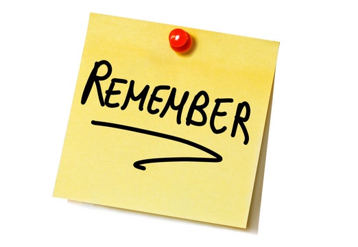 A yellow sticky note pinned with a red thumbtack to a white surface displays the word 'REMEMBER' in bold, black, handwritten…