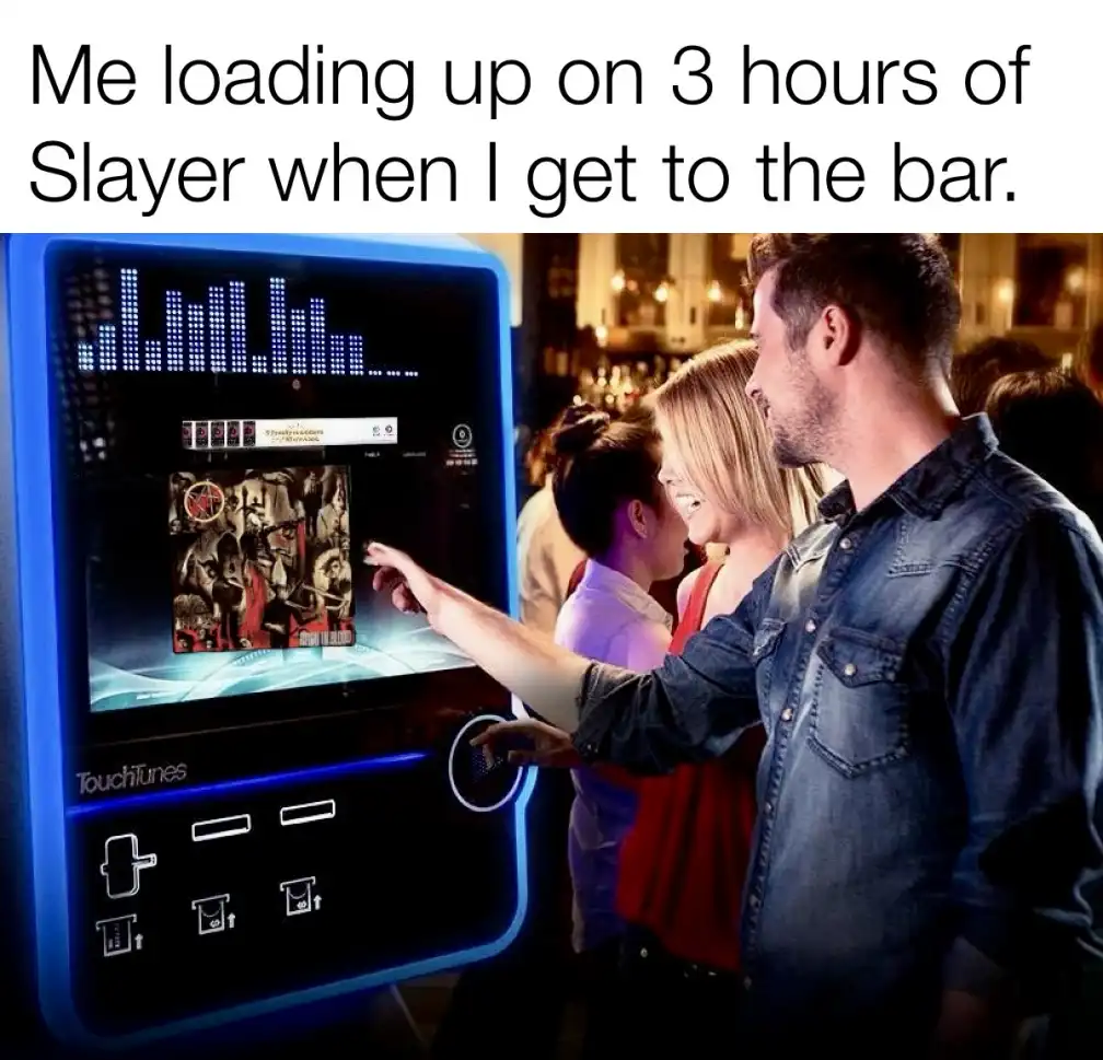 A man and woman are at a bar, interacting with a glowing blue 'Touchtunes' jukebox. The screen displays the album art for…