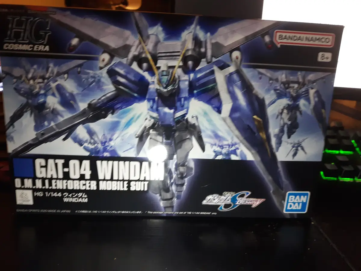 A photo of a Bandai HG 1/144 scale model kit box for the GAT-04 Windam mobile suit from Gundam Seed Destiny, featuring…