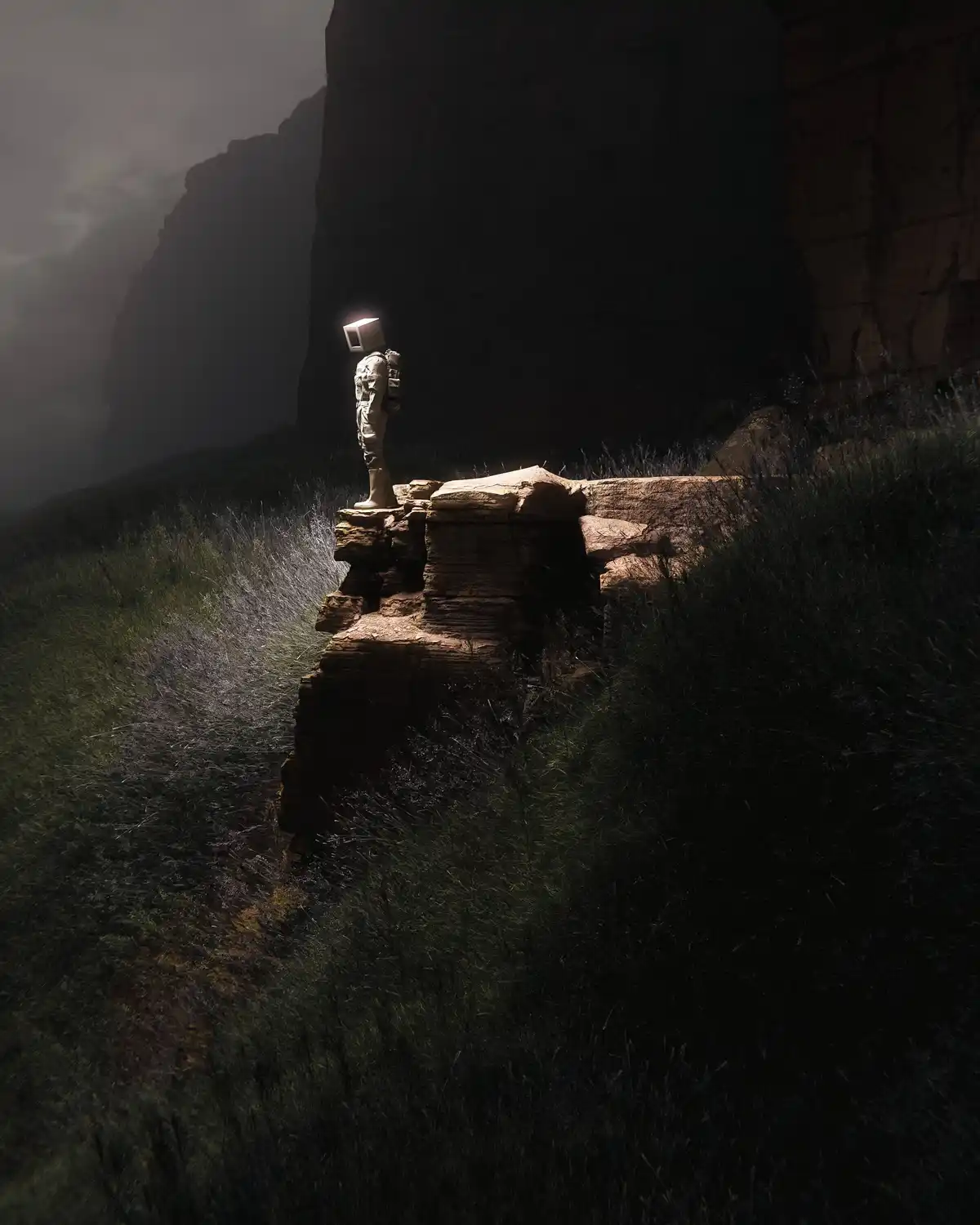 A solitary figure in a spacesuit stands atop a rocky outcrop in a dark, misty canyon, their head replaced by an old-style…
