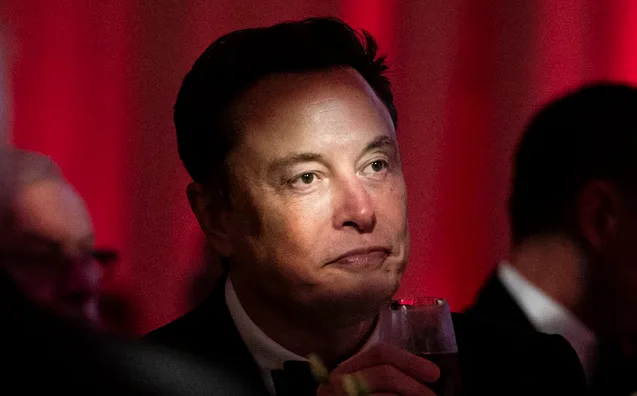 elons face with a glass of wine, looking pensive and slightly annoyed, overlaid with the text 'elons face with a glass of…