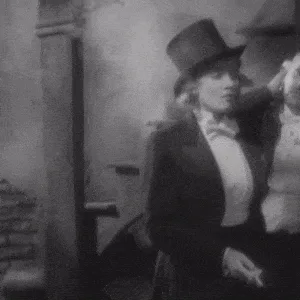 A six-panel black-and-white sequence shows a woman in a top hat and formal attire reacting to a man beside her. In the first…