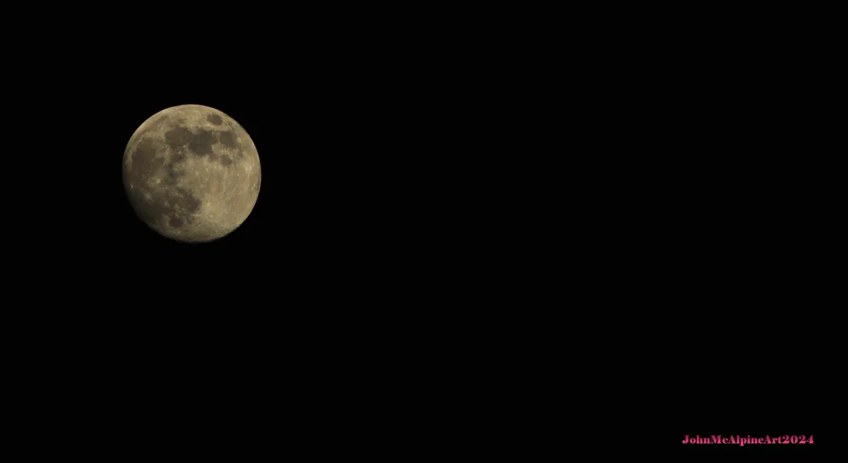 A full moon is visible against a black night sky, with the text 'JohnMcAlpineArt2024' in pink at the bottom right corner…