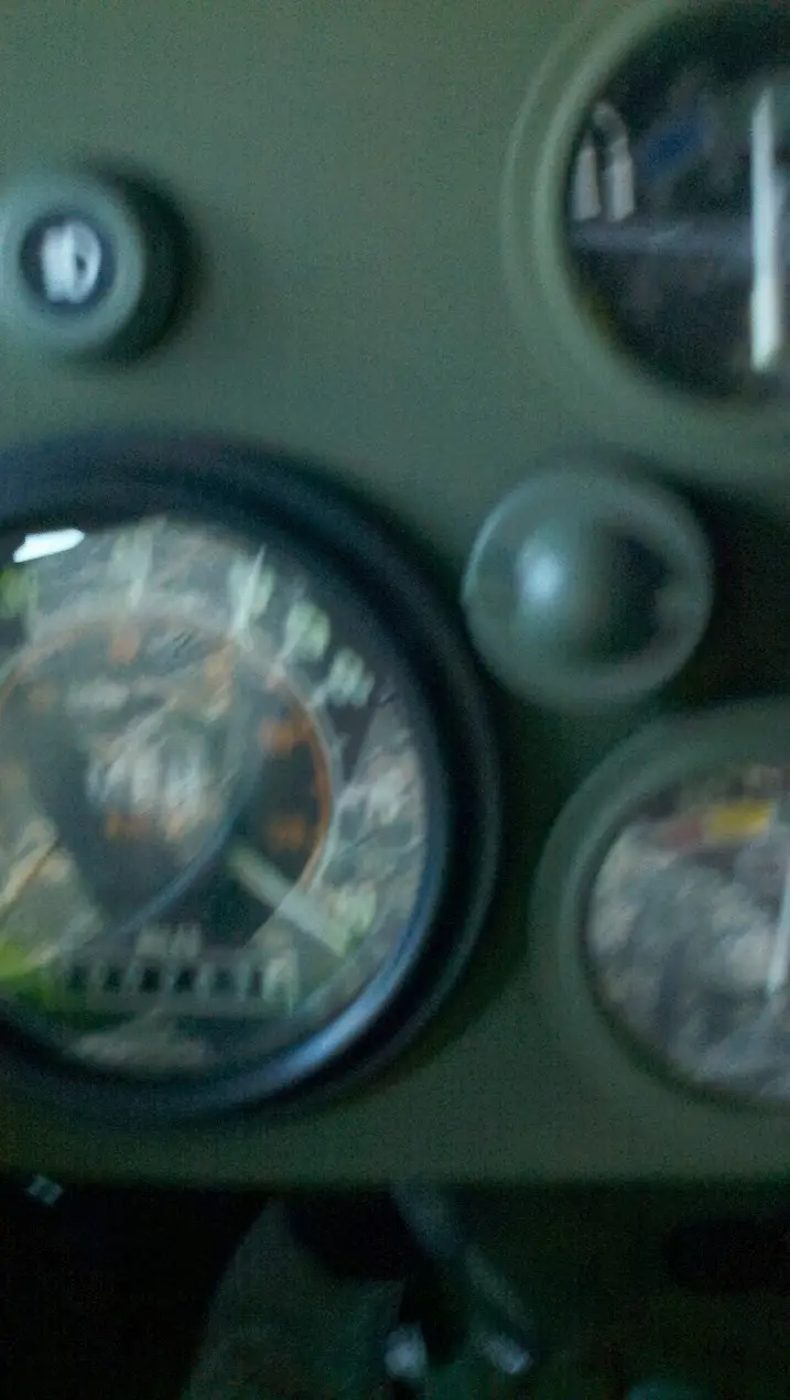 A blurry, low-resolution photo of a vehicle's dashboard with a speedometer and other gauges, overlaid with the text 'i'm not…
