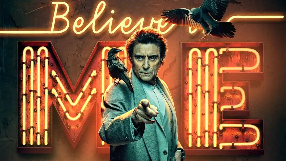 A man with intense eyes and a serious expression points directly at the viewer, with a crow perched on his shoulder and…
