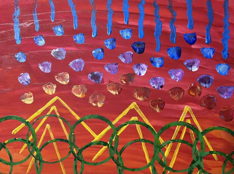 A child's painting depicts a red sky with blue, purple, and orange circular shapes falling like rain or confetti. At the…