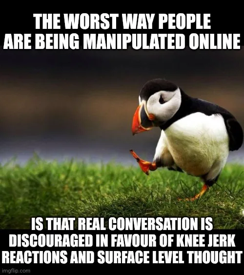 A penguin stands on grass looking down with a slightly confused or unimpressed expression. White bold text at the top reads…