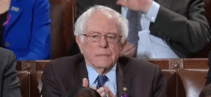 The image shows a sequence of identical frames featuring Senator Bernie Sanders seated in a formal setting, likely a…