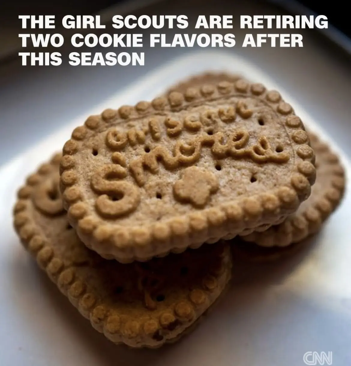 A close-up photo shows a stack of Girl Scout Samoas cookies on a white plate, with the text overlay announcing the…