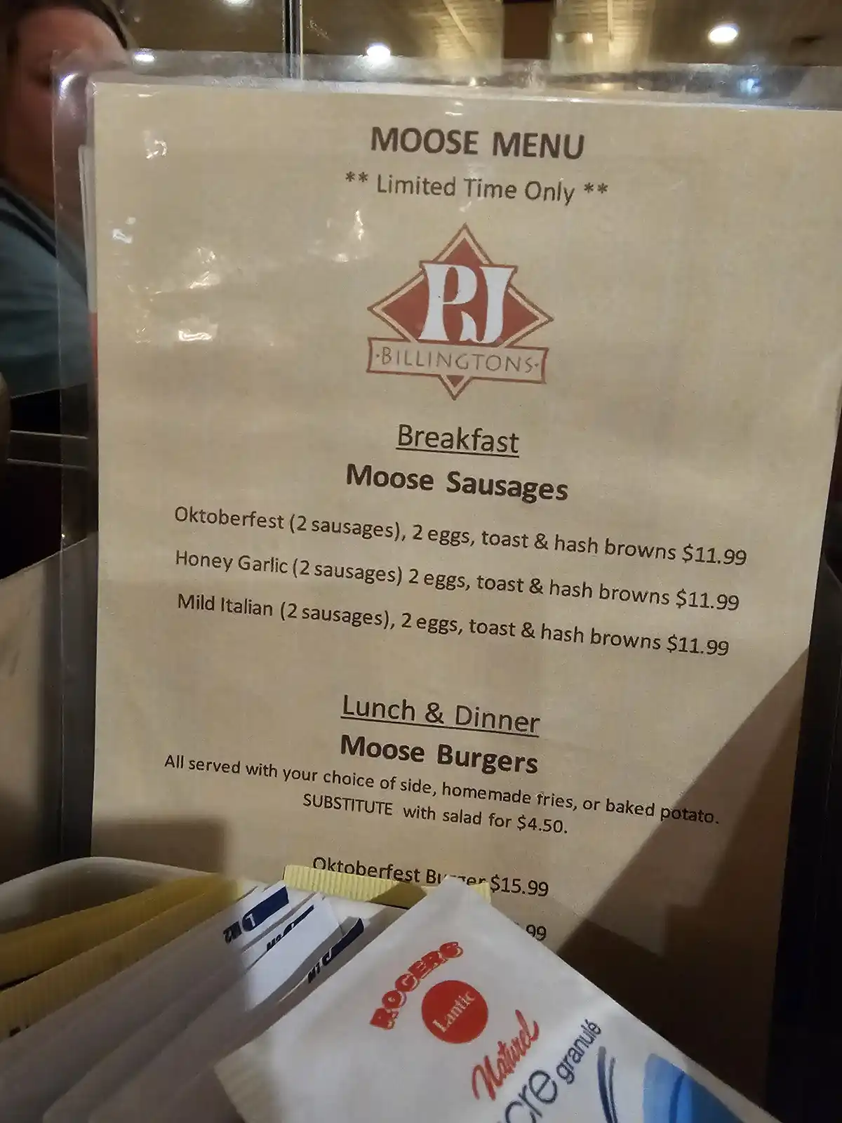 A close-up photo of a restaurant menu titled 'MOOSE MENU' from 'PJ BILLINGTONS', advertising 'Moose Sausages' for breakfast…