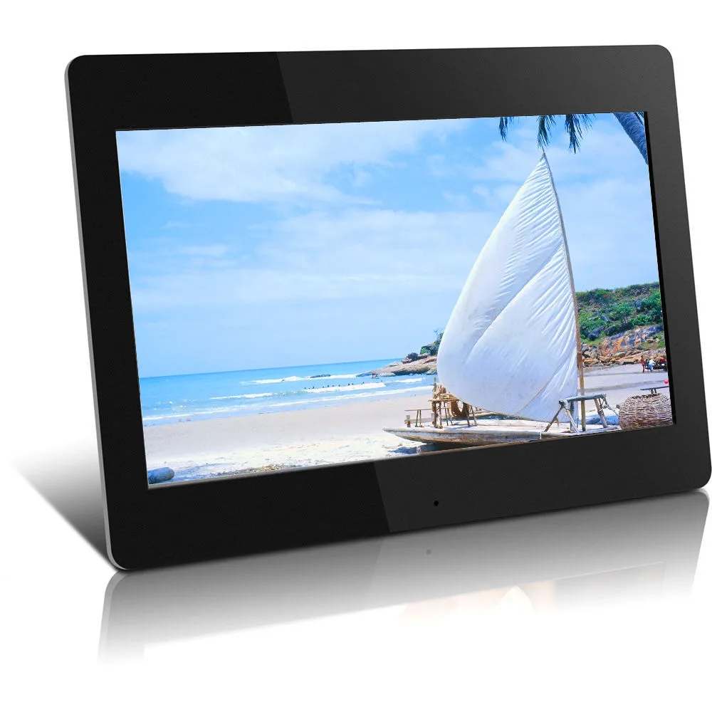 A black digital photo frame displays a serene beach scene with a white sailboat on the sand under a blue sky. The overlaid…