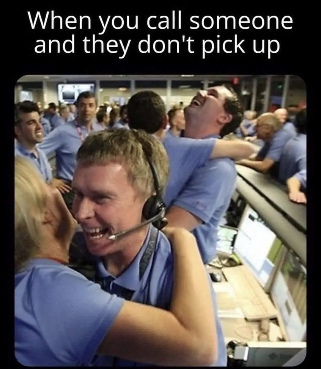A photo shows a group of people in blue uniforms, likely customer service or call center staff, in a bustling office. One…