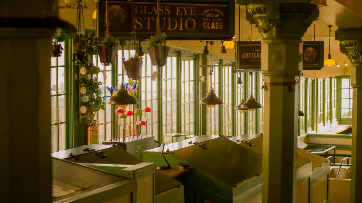 Warm golden light spills from ancient fixtures, illuminating the studio's vintage charm. Dusty bottles and antique tools…