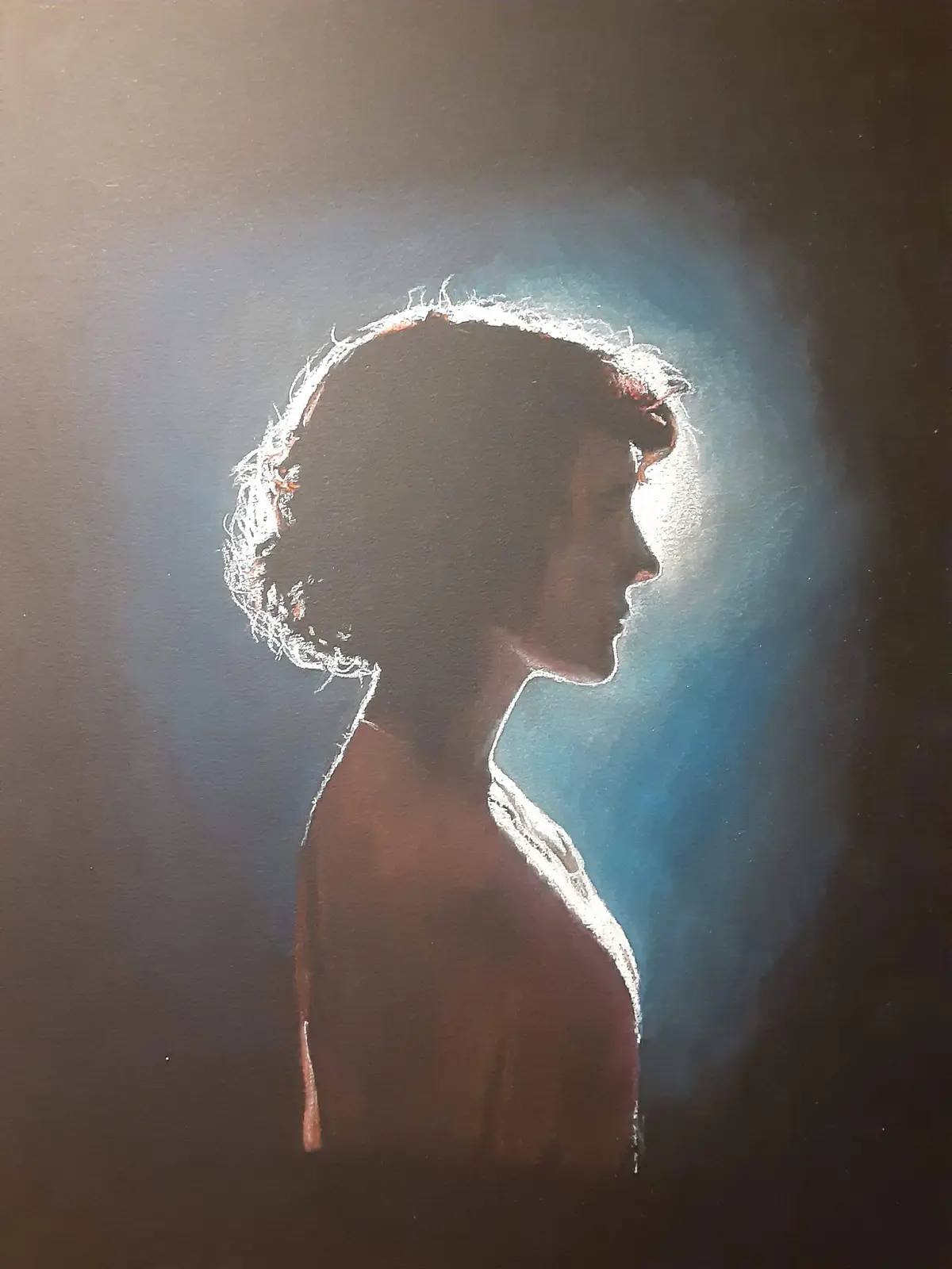 A chalk drawing shows a person's silhouette in profile, outlined in white chalk against a dark background with a blue halo…