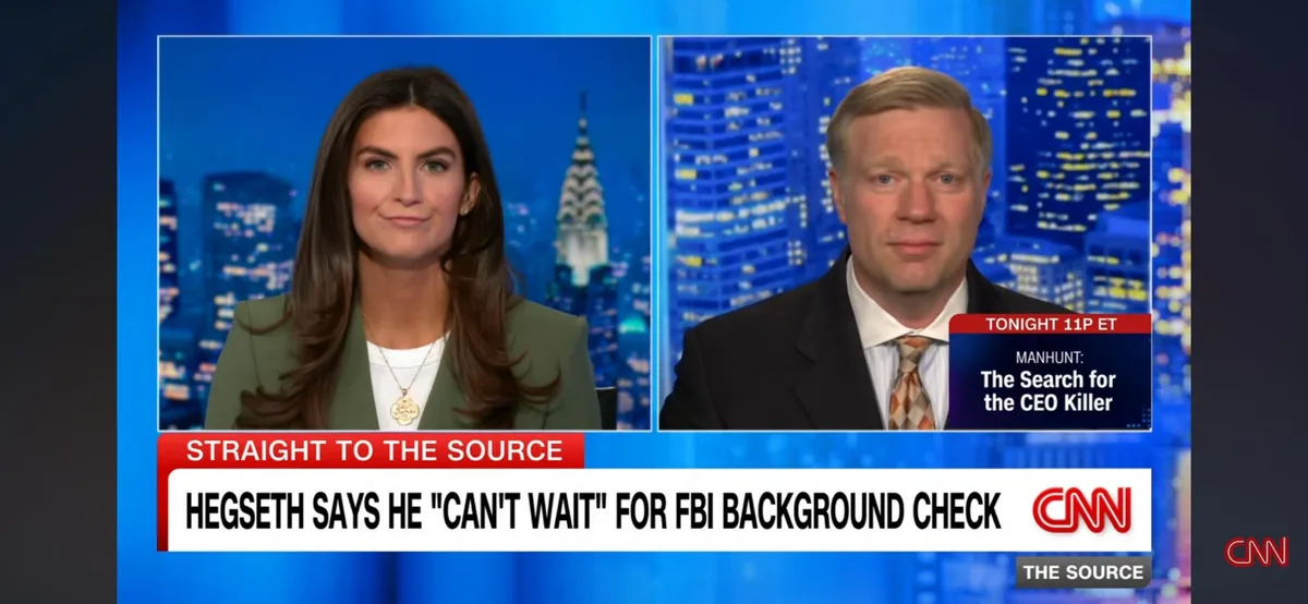 A CNN news broadcast screenshot showing two hosts, a woman on the left and a man on the right, both looking at the camera…
