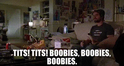A man sits on a couch in a cluttered room, repeatedly shouting 'TITS! TITS! BOOBIES, BOOBIES, BOOBIES.' while gesturing…