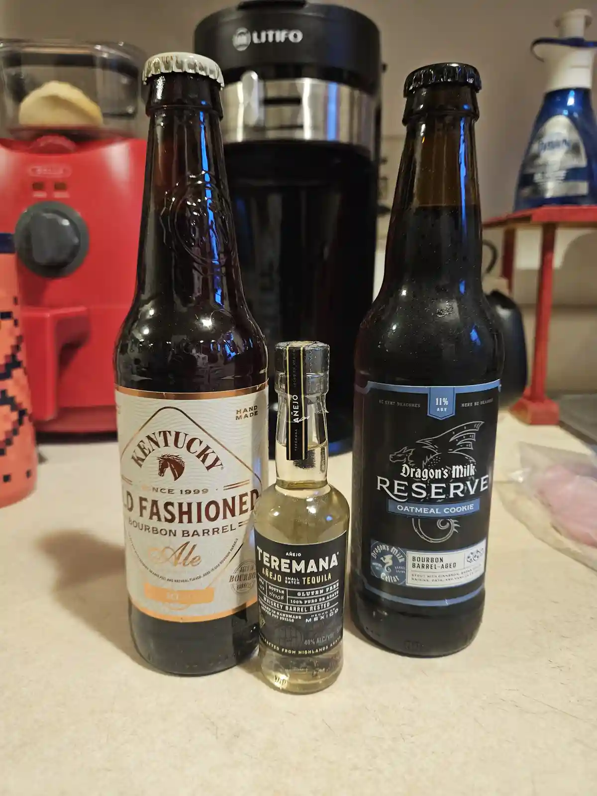 Three bottles of alcoholic beverages — Kentucky Old Fashioned Ale, Teremana Añejo Tequila, and Dragon's Milk Reserve Oatmeal…