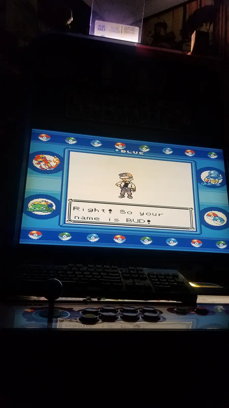 A photo of a Pokémon Red/Blue arcade machine showing the character creation screen where the game confirms the player's name…