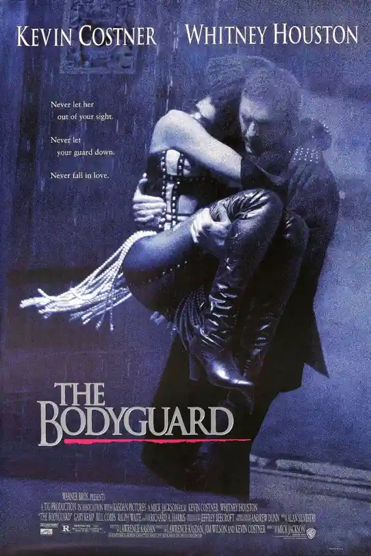 This is a movie poster for 'The Bodyguard' starring Kevin Costner and Whitney Houston. It shows Costner holding Houston in a…