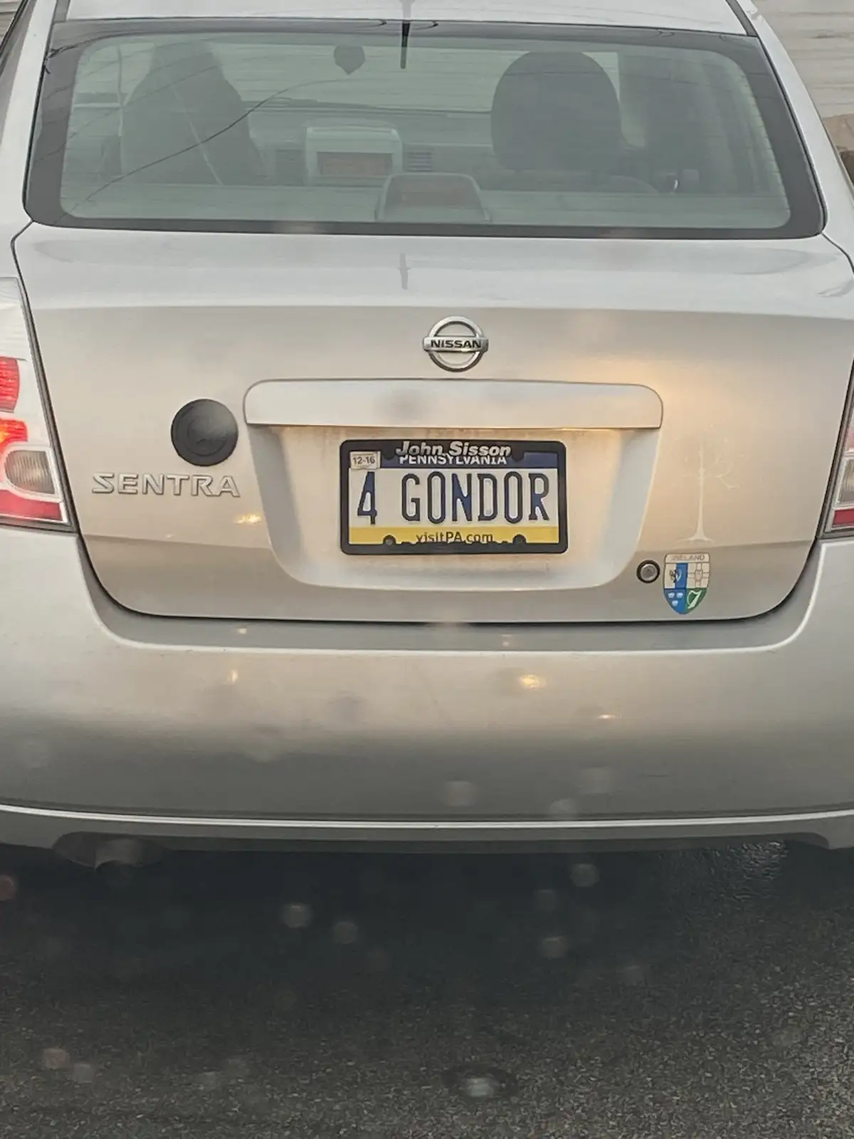 The rear of a silver Nissan Sentra shows a Pennsylvania license plate with the text '4 GONDOR' and the name 'John Sisson' at…