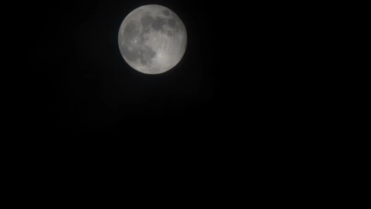 A full moon is centered in a completely black sky, with no other visible objects or features. The overlaid text reads 'i'm…
