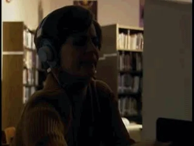 A woman wearing headphones and a brown turtleneck sweater is shown in six panels, her facial expression progressively…