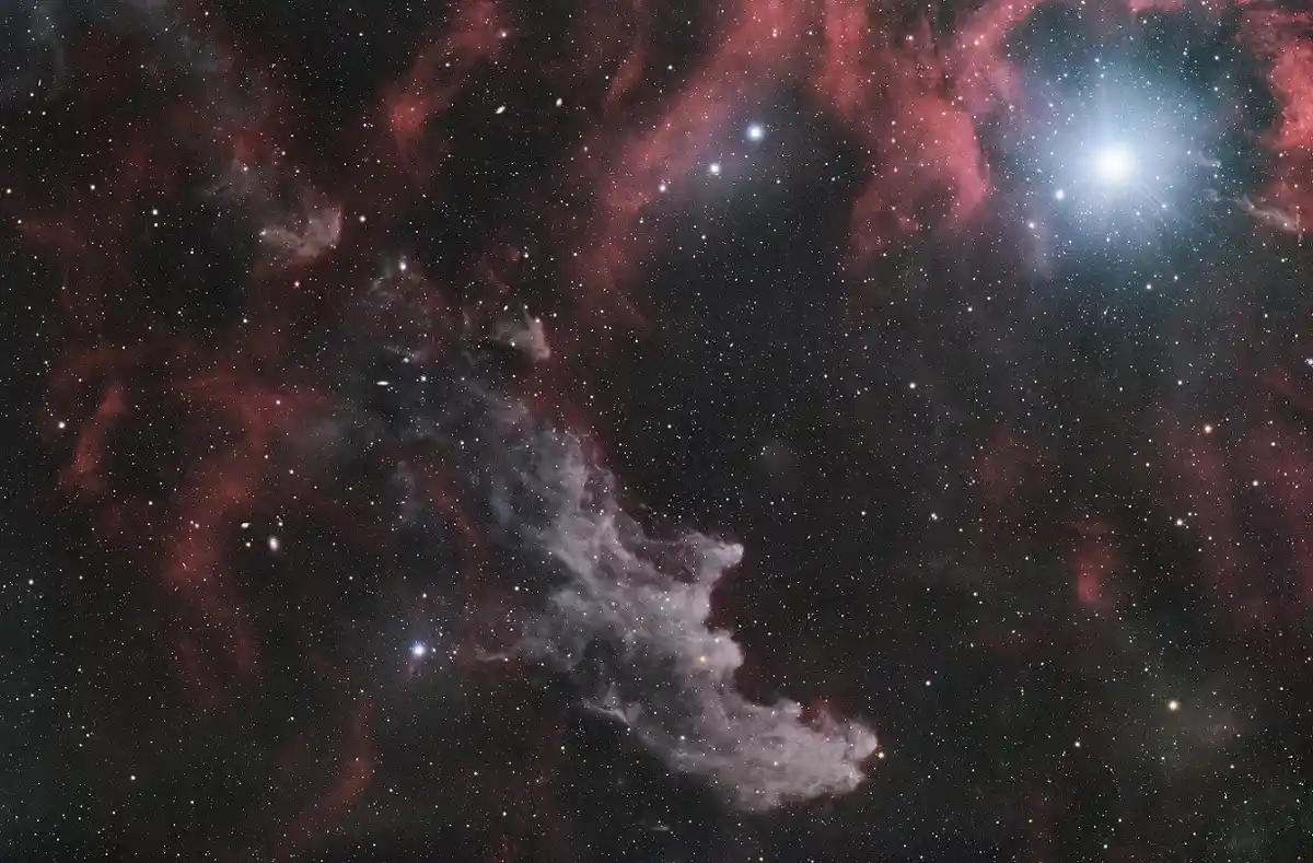 A cosmic image of a starfield with red and white nebulae and bright stars, overlaid with the text 'i'm not a fan of the new…