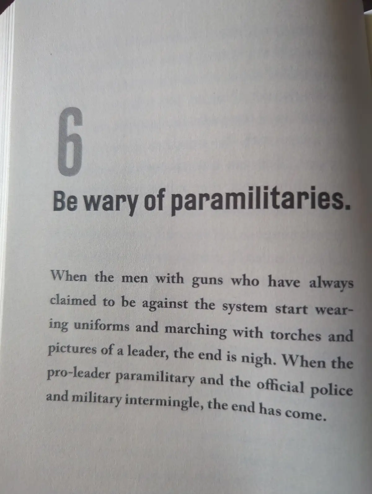 A close-up of a printed page from a book, showing section number 6 titled 'Be wary of paramilitaries.' The text below warns…