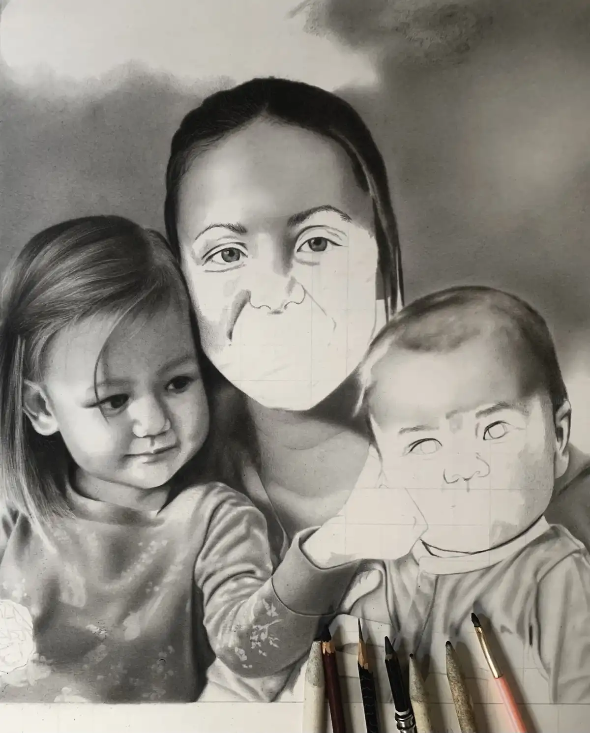 A black-and-white pencil drawing of a woman and two children, where the woman's and the baby's faces are partially covered…
