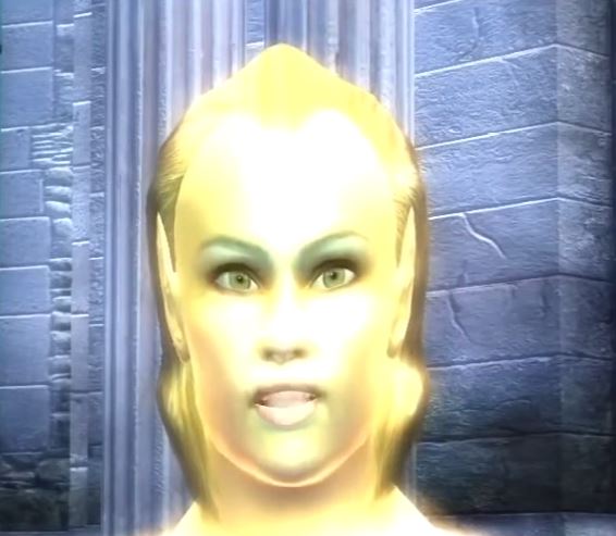 A close-up of a video game character with a glowing yellow face and intense green eyes, standing in front of a stone wall…