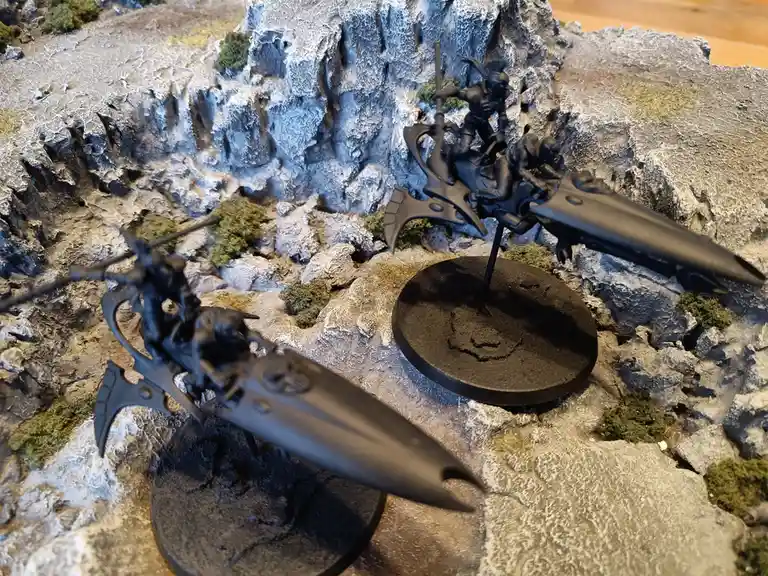 Two black-painted miniature warhammer 40k flyers are positioned on a rocky terrain diorama. The text overlay reads 'i'm not…