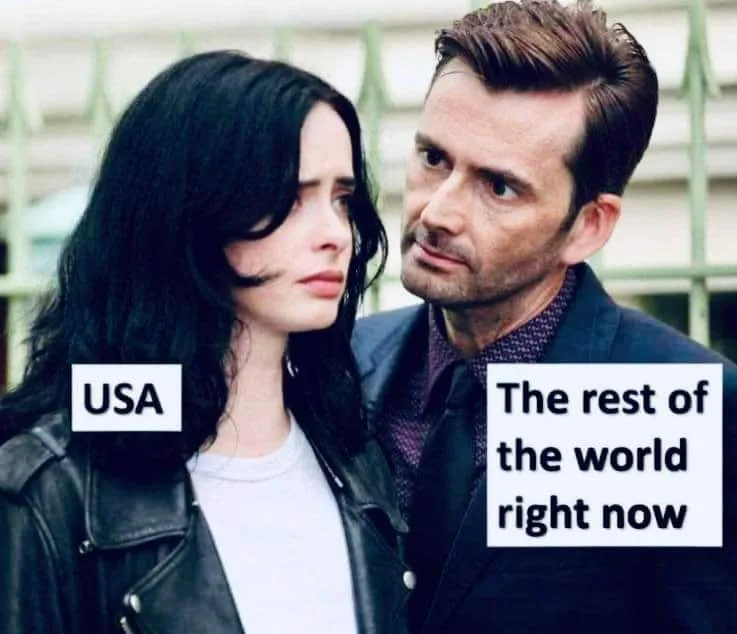 A man and a woman stand close together, the woman on the left labeled 'USA' and the man on the right labeled 'The rest of…