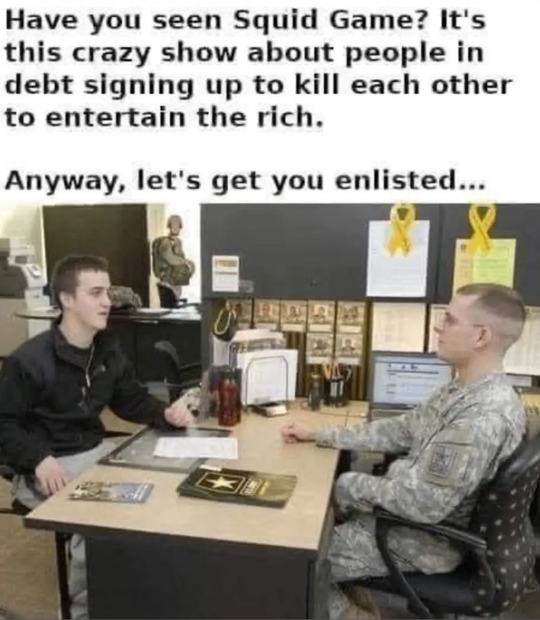 Two men sit across a desk in what appears to be a military recruitment office. One man, in civilian clothes, faces a soldier…