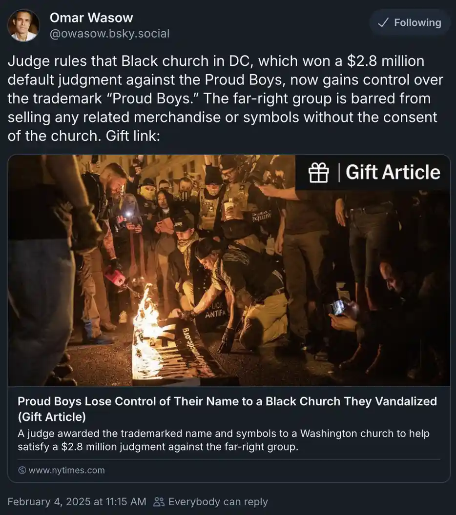 A screenshot of a social media post showing a nighttime photo of a group of men, some in tactical gear, burning a banner on…