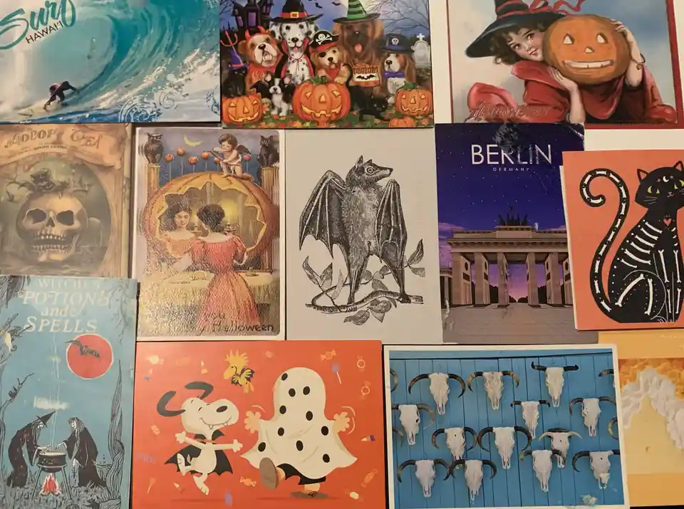 A collage of various postcards and images including a surfer in Hawaii, Halloween dogs with pumpkins, a vintage witch with a…