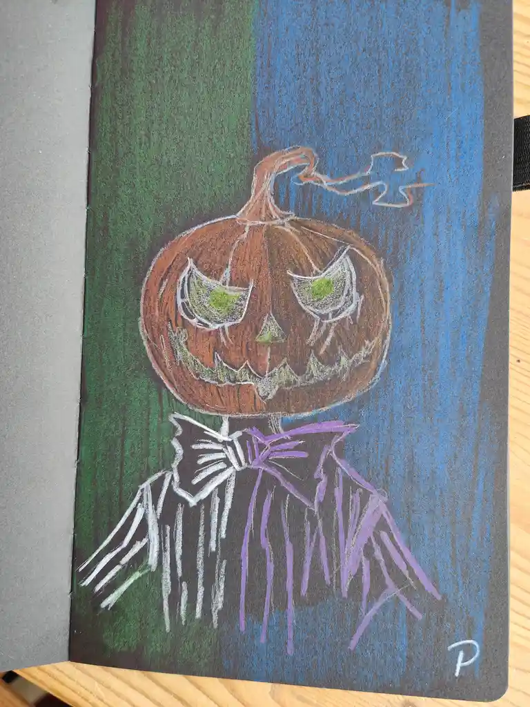A chalk drawing on dark paper shows a jack-o'-lantern with glowing green eyes and a jagged grin, wearing a black robe with a…